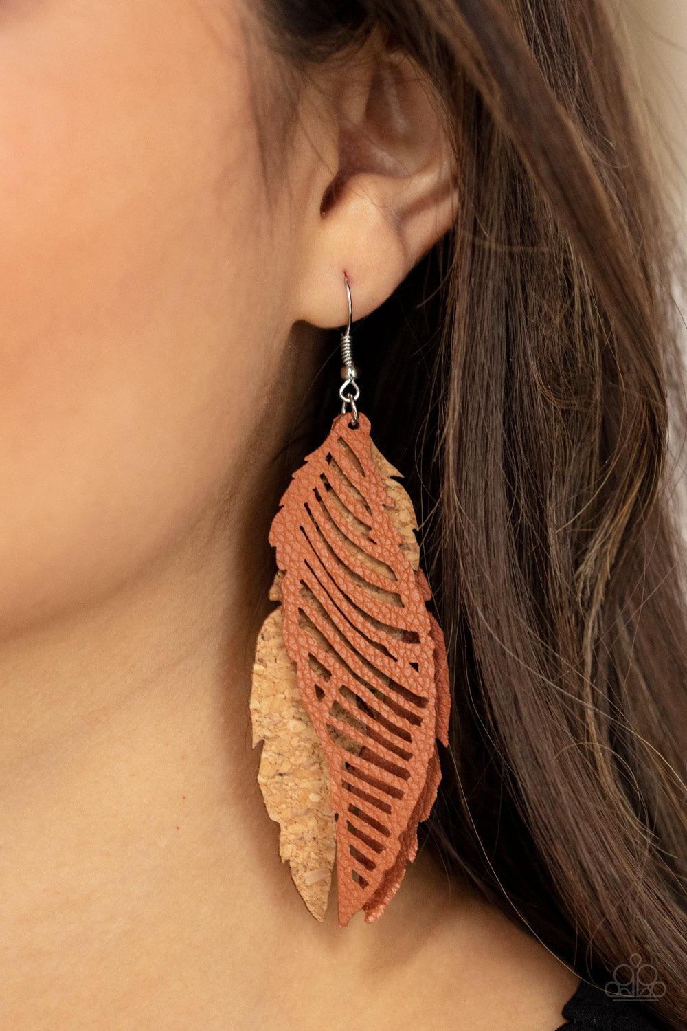 Paparazzi Accessories WINGING Off The Hook - Brown A mismatched collection of cork and brown leather feather frames flutter from the ear, layering into a free-spirited lure. Earring attaches to a standard fishhook fitting. Sold as one pair of earrings. Je