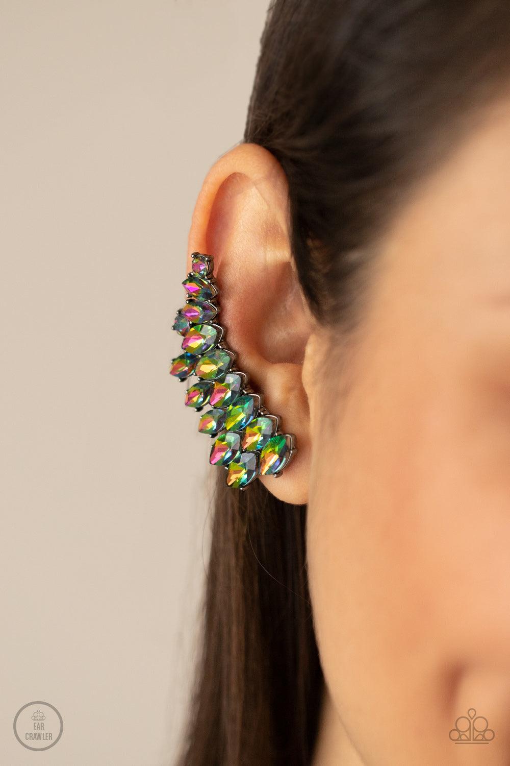 Paparazzi Accessories Explosive Elegance - Multi An explosion of marquise-cut oil spill rhinestones delicately climb the ear, coalescing into a smoldering frame. Earring attaches to a standard post fitting. Features a clip-on fitting at the top for a secu