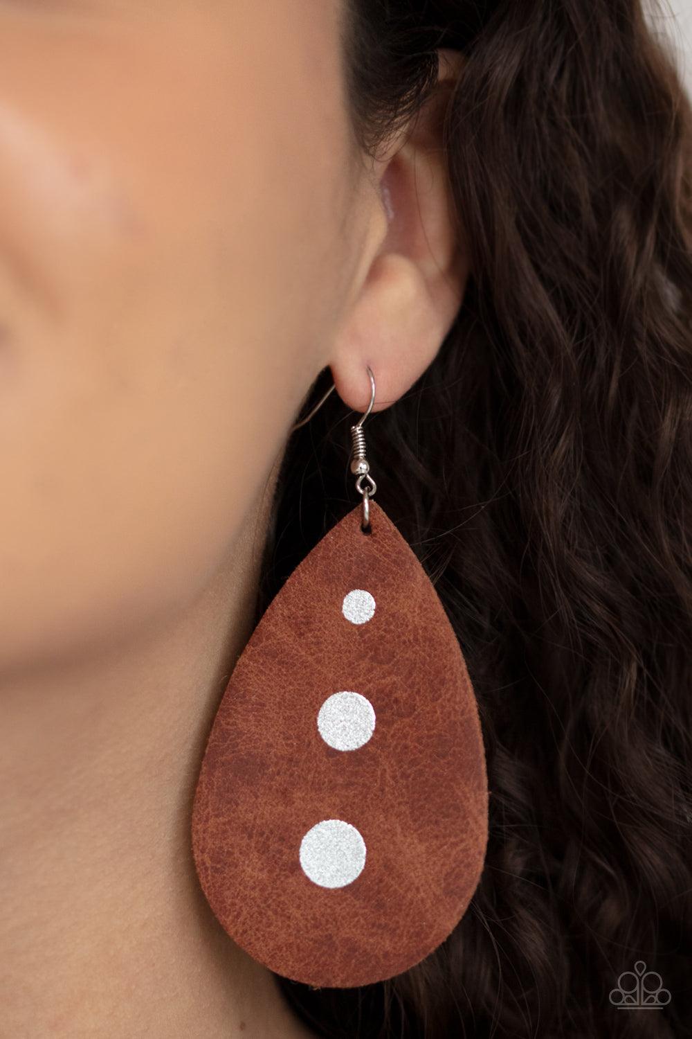 Paparazzi Accessories Rustic Torrent - Brown The front of a distressed leather teardrop frame is adorned into three shimmery silver paint drops, creating a rustic elegance. Earring attaches to a standard fishhook fitting. Sold as one pair of earrings. Ear