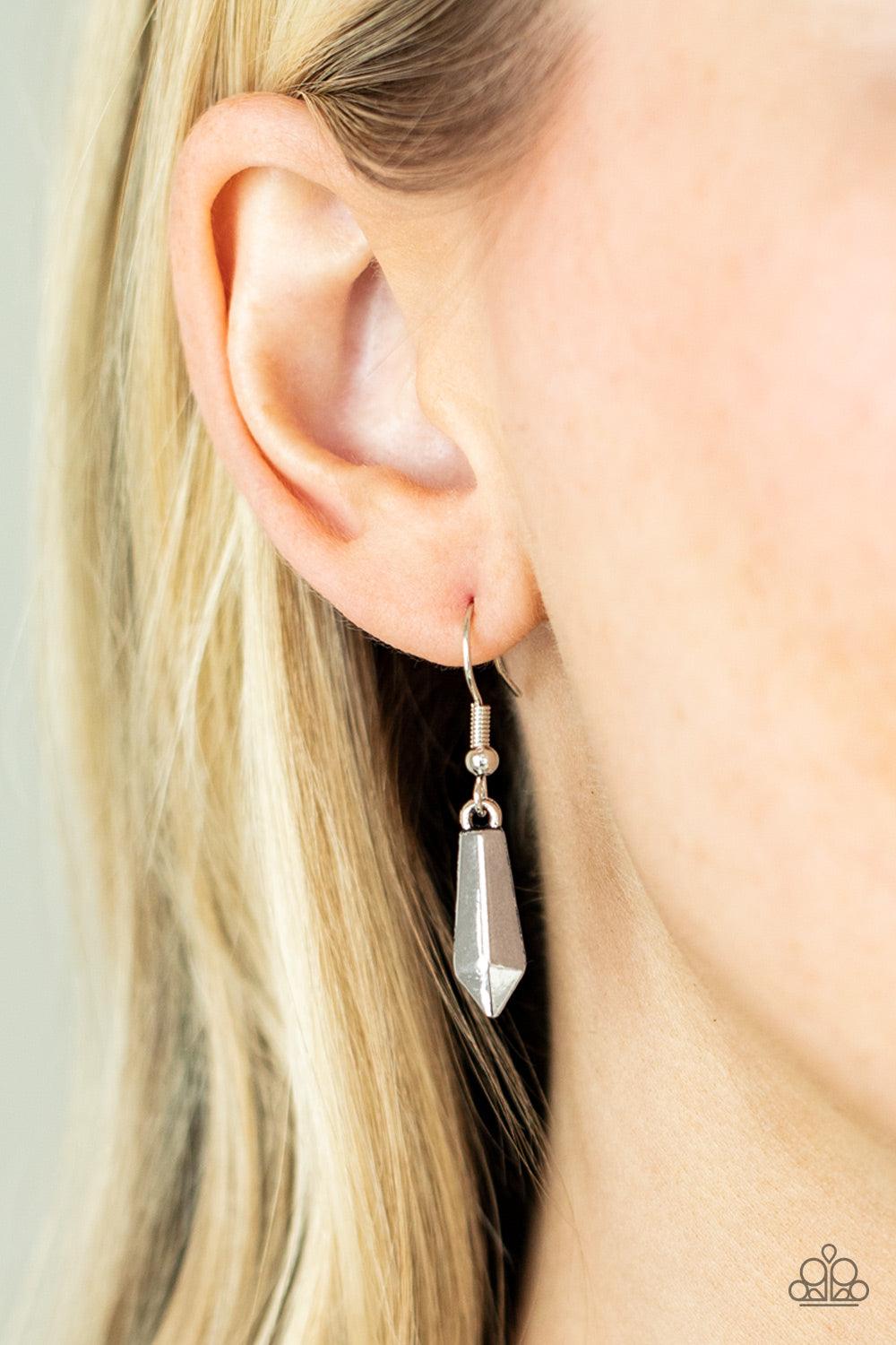 Paparazzi Accessories Dangerous Dazzle - White Pairs of glittery white rhinestones alternate between flared silver rods that are threaded along two rows of flat silver chains, creating a dangerous fringe below the collar. Features an adjustable clasp clos