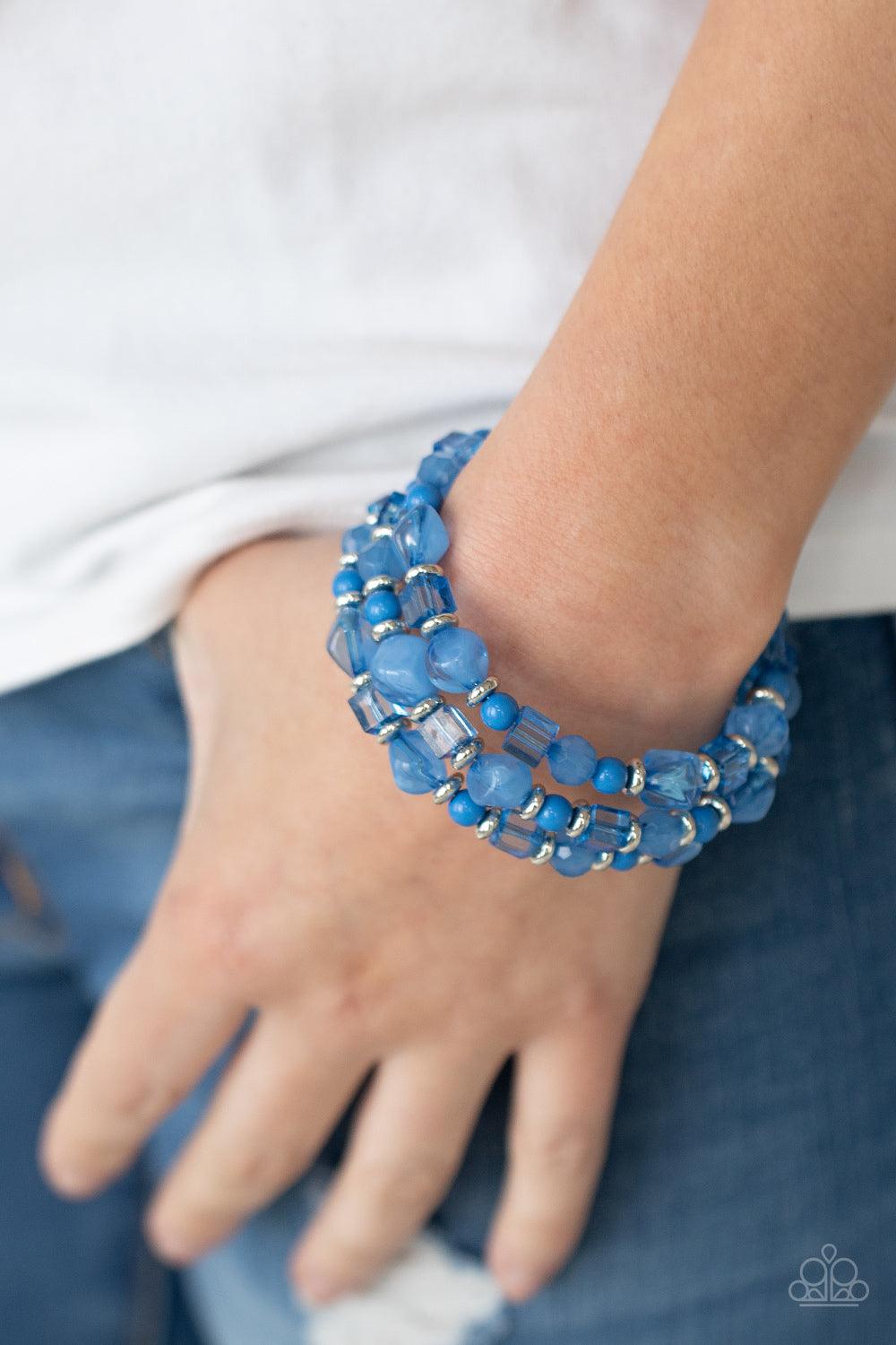 Paparazzi Accessories Girly Girl Glimmer - Blue Featuring glassy, polished, and opaque finishes, a whimsical collection of French Blue pebble, crystal, and acrylic beads are threaded along a dainty wire, creating a colorful infinity wrap bracelet around t