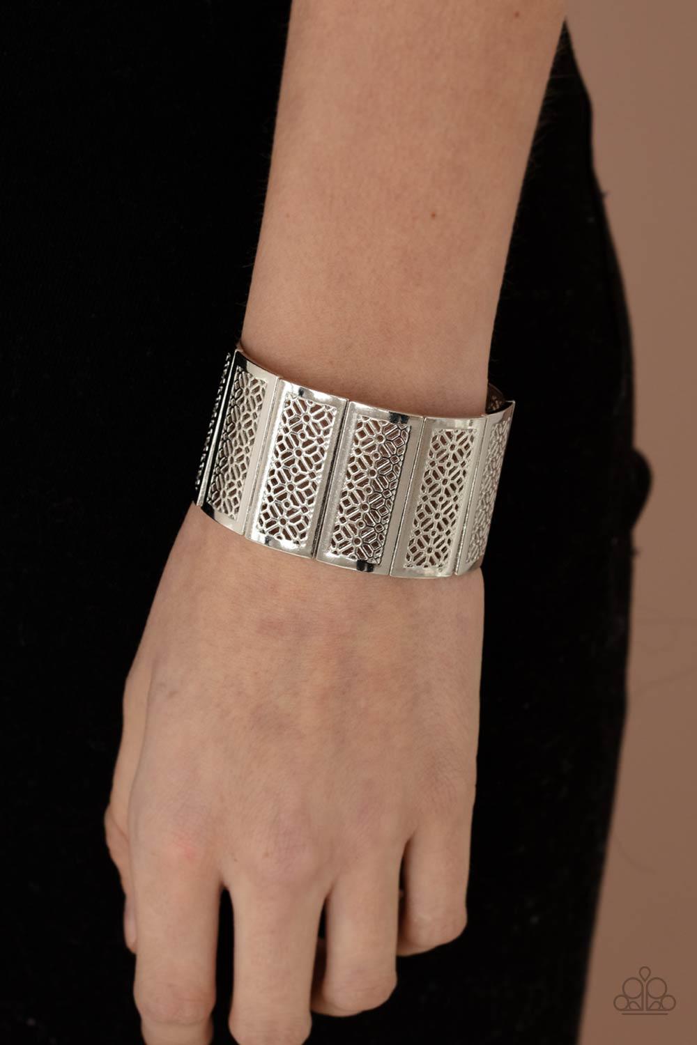 Paparazzi Accessories Thai Terrariums - Silver Filled with airy stenciled floral patterns, rectangular silver frames are threaded along stretchy bands around the wrist, creating a whimsical centerpiece. Sold as one individual bracelet. Jewelry