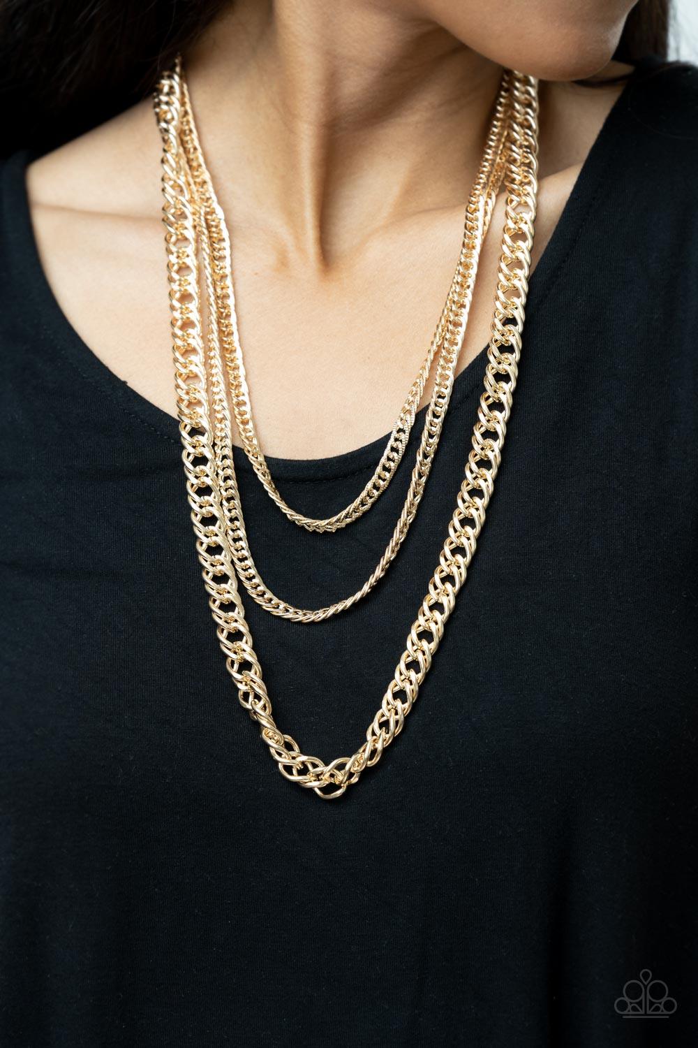 Paparazzi Accessories Chain of Champions - Gold Bold layers of glistening gold chain of varying sizes and textures, fall like a weighty medal across the chest creating a shimmering industrial effect. Features an adjustable clasp closure. Sold as one indiv