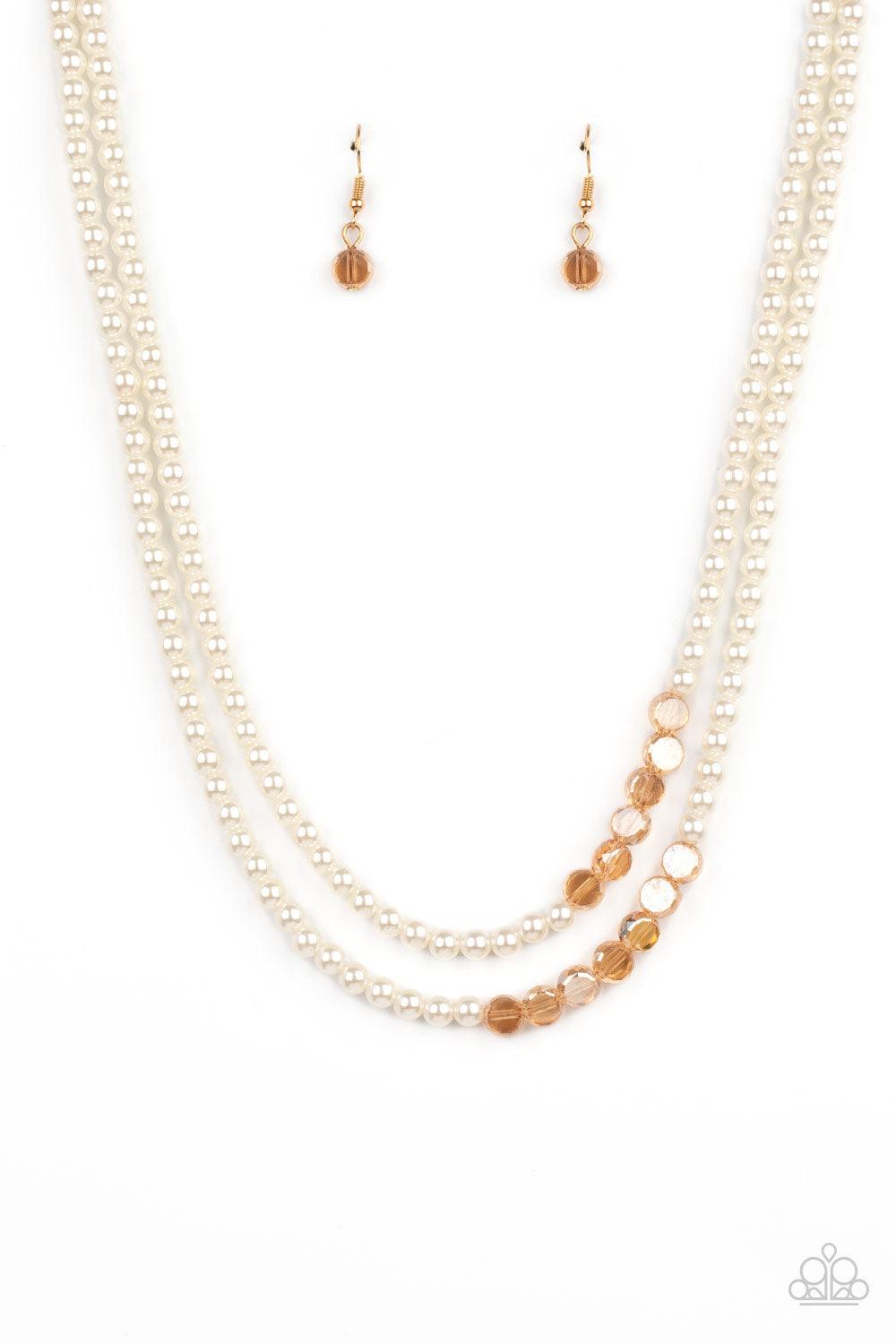 Paparazzi Accessories Poshly Petite - Gold A posh collection of pearly white beads, accented with sections of flat, faceted shimmery transparent gold beads, is threaded along invisible wires, creating sophisticated layers that fall below the collar. Featu