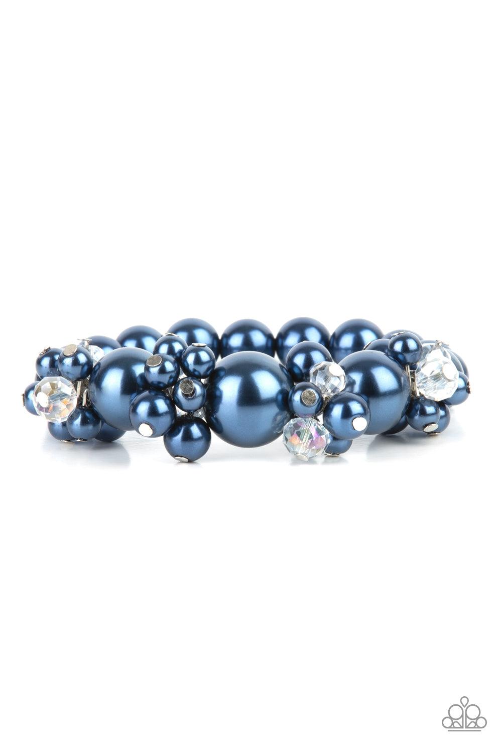 Paparazzi Accessories Upcycled Upscale - Blue Dainty blue pearls and sparkly white crystal-like beads cluster between oversized blue pearls that are threaded along stretchy bands around the wrist, creating a stunning centerpiece. Sold as one individual br