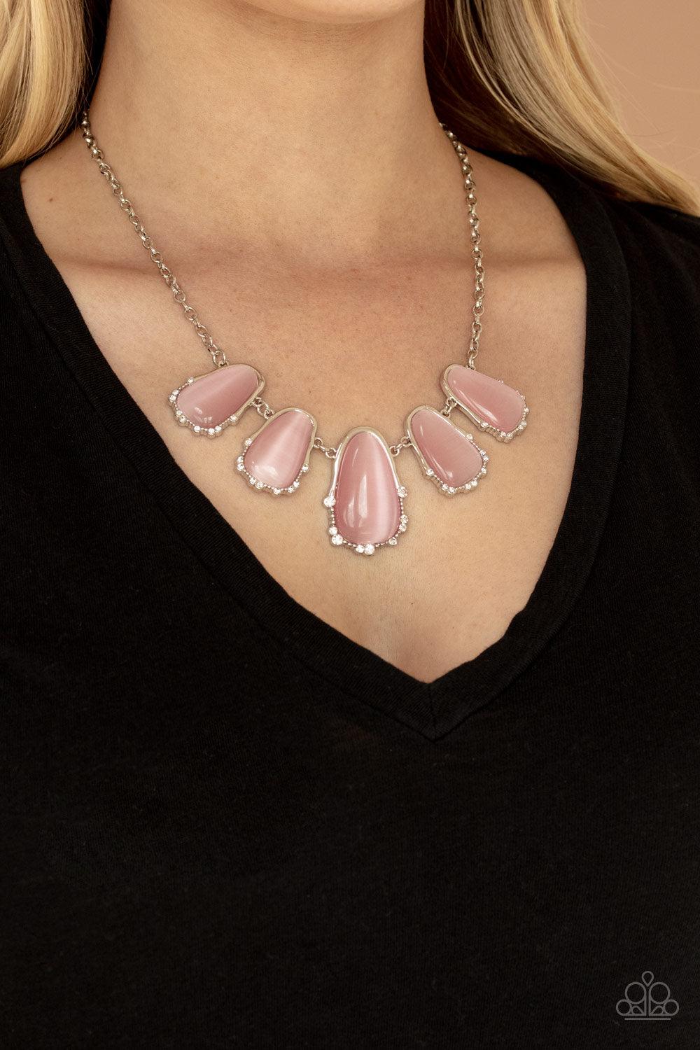 Paparazzi Accessories Newport Princess - Pink A collection of asymmetrical pink cat’s eye stone teardrops are encased inside imperfect silver frames as they delicately link below the collar. The dainty silver frames are sporadically dotted in dainty silve