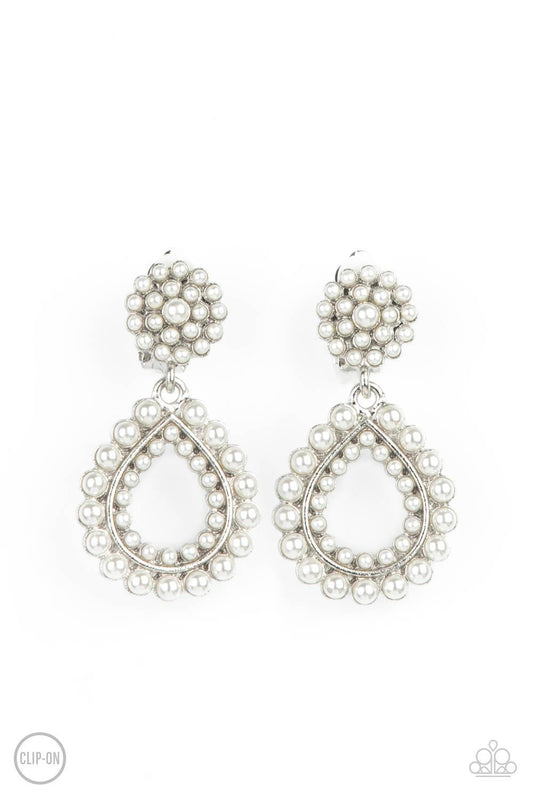 Paparazzi Accessories Discerning Droplets - White *Clip-On Droplets of pearls dot the surface of a silver teardrop frame that suspends from a round pearl encrusted disc for a classic finish. Earring attaches to a standard clip-on fitting. Sold as one pair
