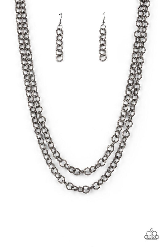 Paparazzi Accessories Grunge Goals - Black A seemingly infinite collection of textured gunmetal links connect into two dramatic rows across the chest, creating an intense industrial display. Features an adjustable clasp closure. Sold as one individual nec