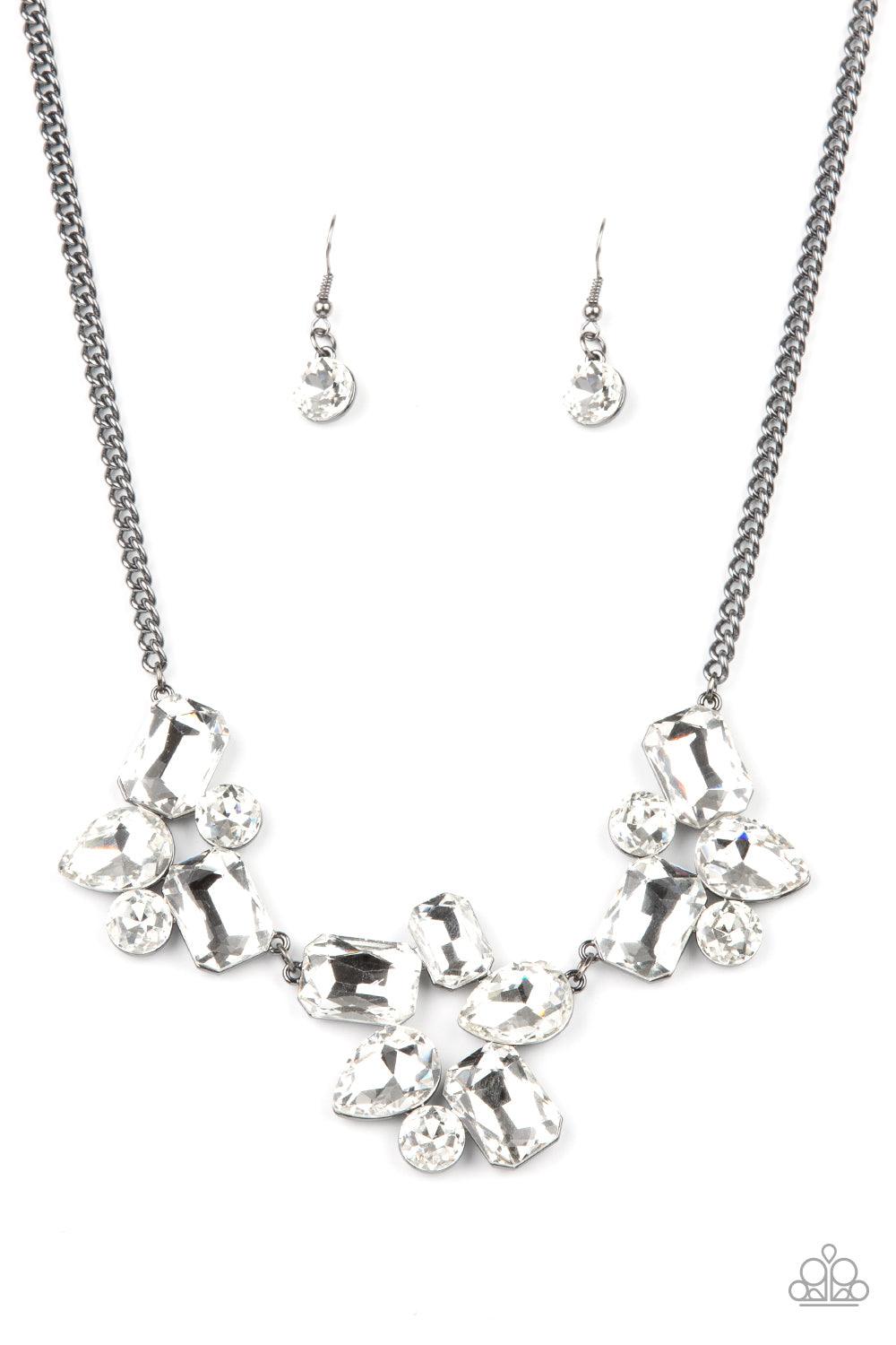 Paparazzi Accessories Galactic Goddess - Black An unexpected explosion of oversized round, teardrop, and emerald cut rhinestones cluster into haphazard groupings. The blinding clusters link together, creating a stellar statement piece that sits below the
