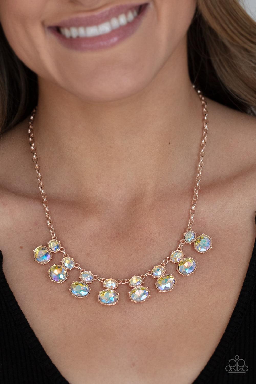 Paparazzi Accessories Cosmic Countess - Rose Gold Double stacks of iridescent oval cut gems link elegantly across the collar on a rose gold chain for a deliriously cosmic flair of glamour. Features an adjustable clasp closure. Sold as one individual neckl