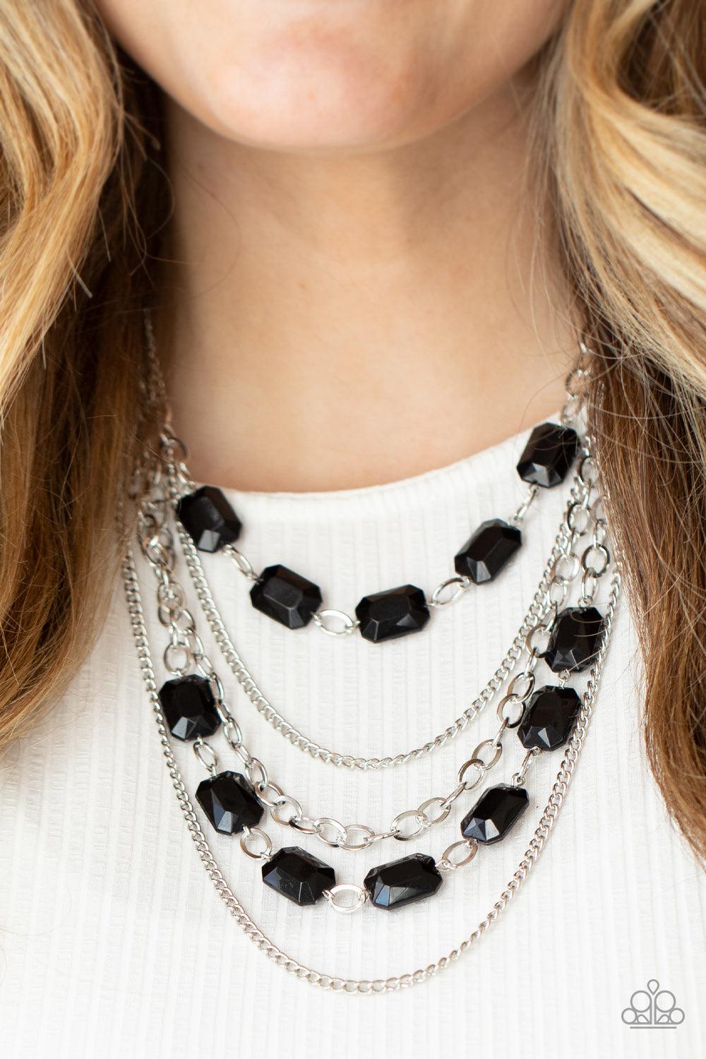 Paparazzi Accessories Standout Strands - Black A stunning collection of silver chains and shiny rectangular black beads, falls in layers across the chest for a glamorous standout statement. Features an adjustable clasp closure. Sold as one individual neck