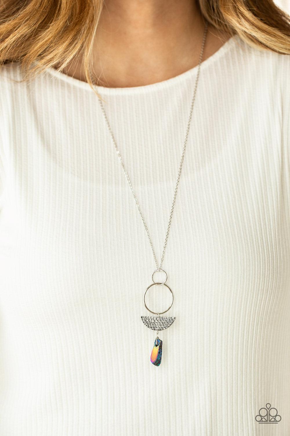 Paparazzi Accessories Monumental Obelisk - Multi Silver hoops, a slice of textured semi-circle disc, and a hammered multicolored stone-like obelisk pendant all dangle from a long chain for a trend-setting combination. Features an adjustable clasp closure.