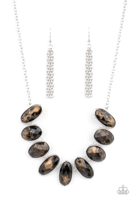 Paparazzi Accessories Elliptical Episode - Black Generous glossy black gems, dusted in shimmery gold, lay in silver oval frames and link across the collar creating a glimmering statement. Features an adjustable clasp closure. Sold as one individual neckla
