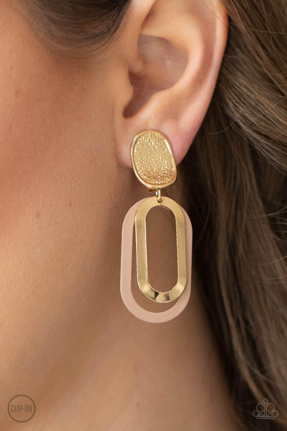 Paparazzi Accessories Melrose Mystery - Brown *Clip-On Shiny gold and Iced Coffee oblong hoops dangle one in front of the other from a shimmery textured gold oval disc for an upscale finale. Earring attaches to a standard clip-on fitting. Sold as one pair