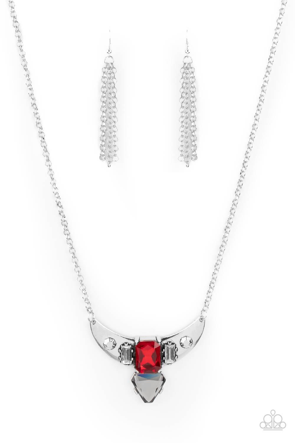 Paparazzi Accessories You the TALISMAN! - Red Pairs of faceted silver beads and glassy white emerald cut gems flank an oversized emerald cut red gem atop an antiqued silver half moon frame. A smoky triangular cut gem adorns the bottom of the pendant, crea