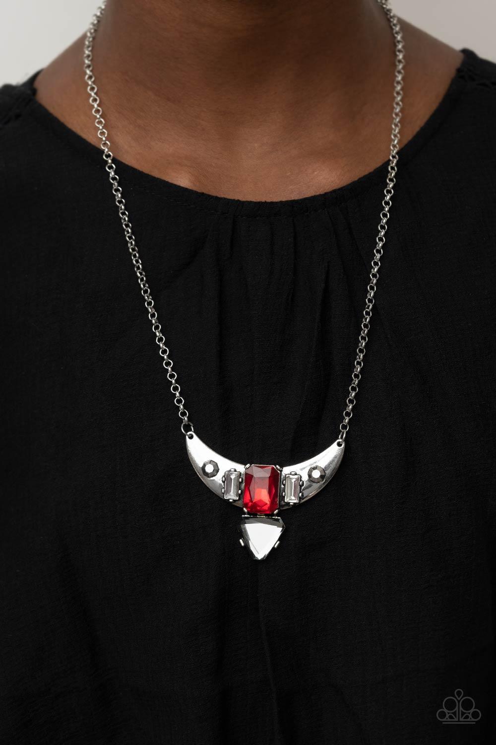 Paparazzi Accessories You the TALISMAN! - Red Pairs of faceted silver beads and glassy white emerald cut gems flank an oversized emerald cut red gem atop an antiqued silver half moon frame. A smoky triangular cut gem adorns the bottom of the pendant, crea
