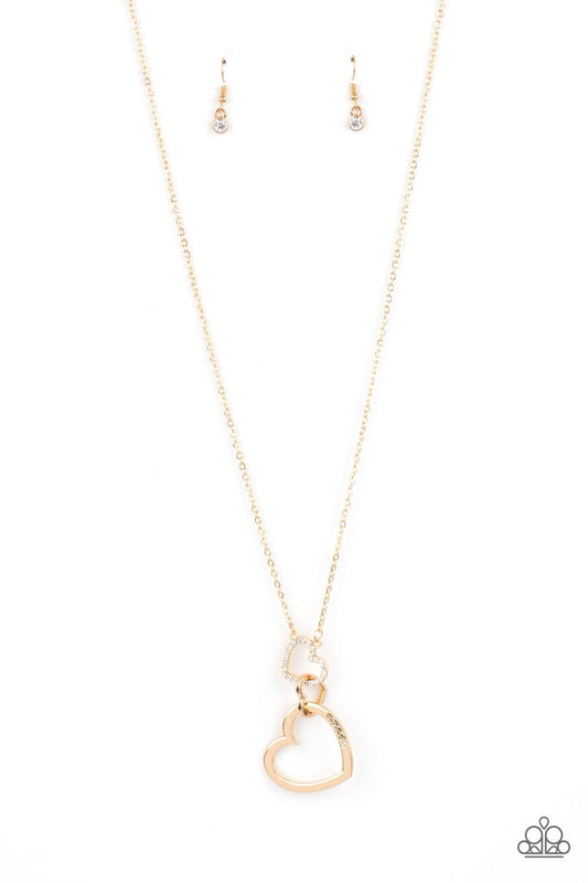 Paparazzi Accessories Grandma Glow - Gold A gold heart engraved with the word "Grandma," dangles from two smaller hearts at the bottom of a lengthened shimmery gold chain. The first heart is accented with sparkly white rhinestones creating an affectionate