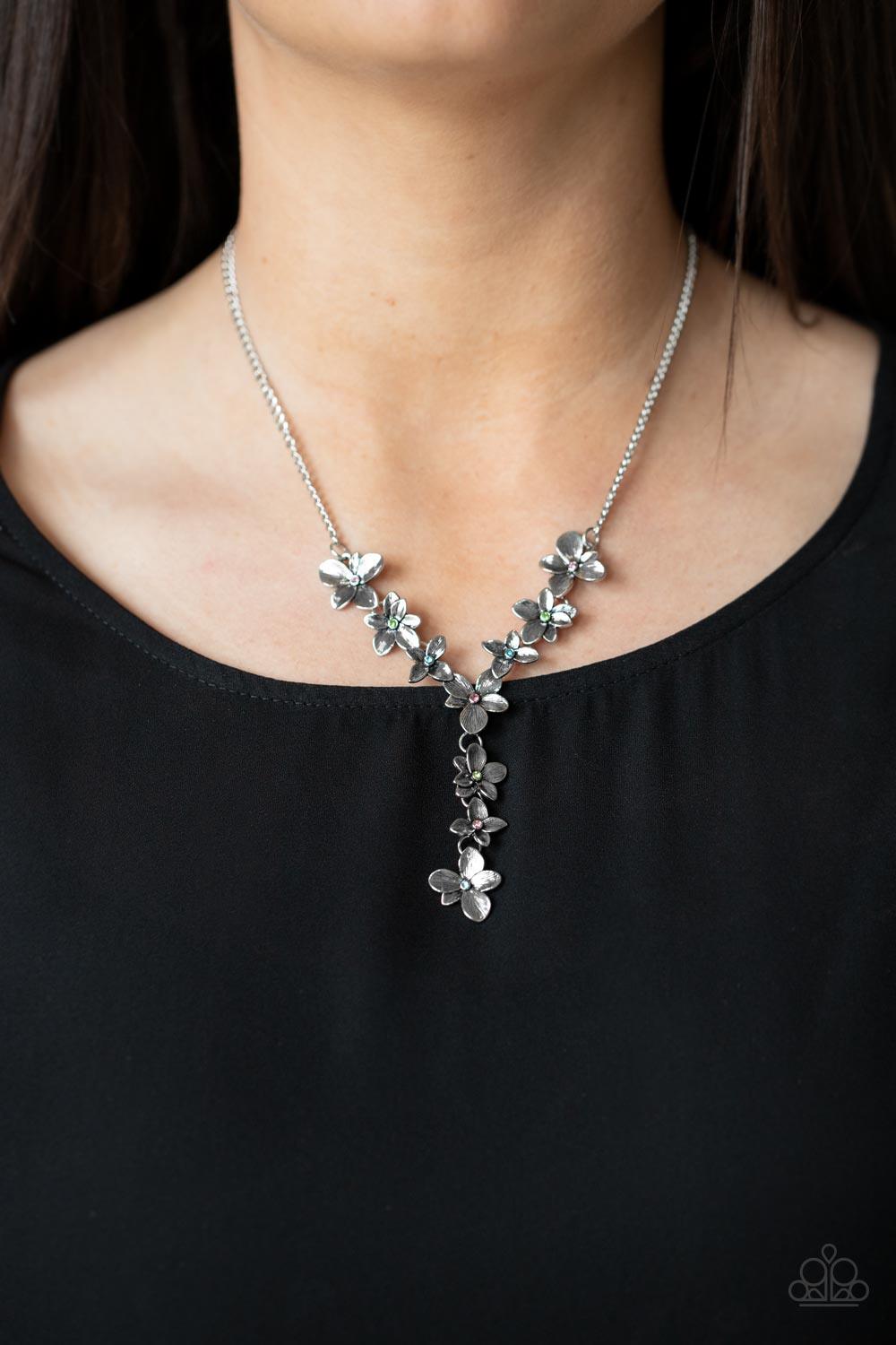 Paparazzi Accessories Fairytale Meadow - Multi Dotted with dainty multicolored rhinestone centers, whimsical silver flowers delicately link into an extended pendant below the collar for an ethereal fashion. Features an adjustable clasp closure. Sold as on