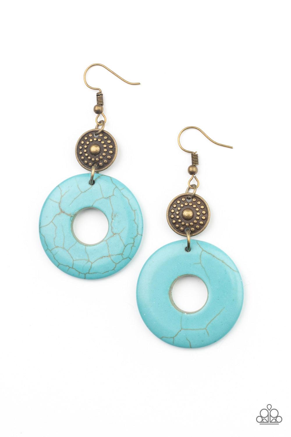 Paparazzi Accessories Earthy Epicenter - Brass A large turquoise ring dangles from an antiqued brass disc, accented with raised dots in concentric circles. The timeless combination of turquoise and brass and the intricate textures bring an undeniably arti