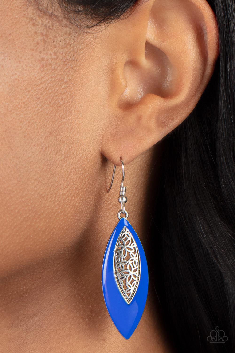 Paparazzi Accessories Venetian Vanity - Blue Asymmetrically bordered in a bright Mykonos Blue frame, airy silver filigree blooms along the center of a colorful lure for a seasonal flair. Earring attaches to a standard fishhook fitting. Sold as one pair of