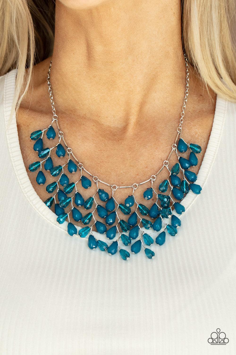 Paparazzi Accessories Garden Fairytale - Blue A shimmery collection of opaque and clear crystal-like Mykonos Blue teardrop beads delicately cluster along a linked strand of silver bars, creating an ethereally leafy fringe below the collar. Features an adj