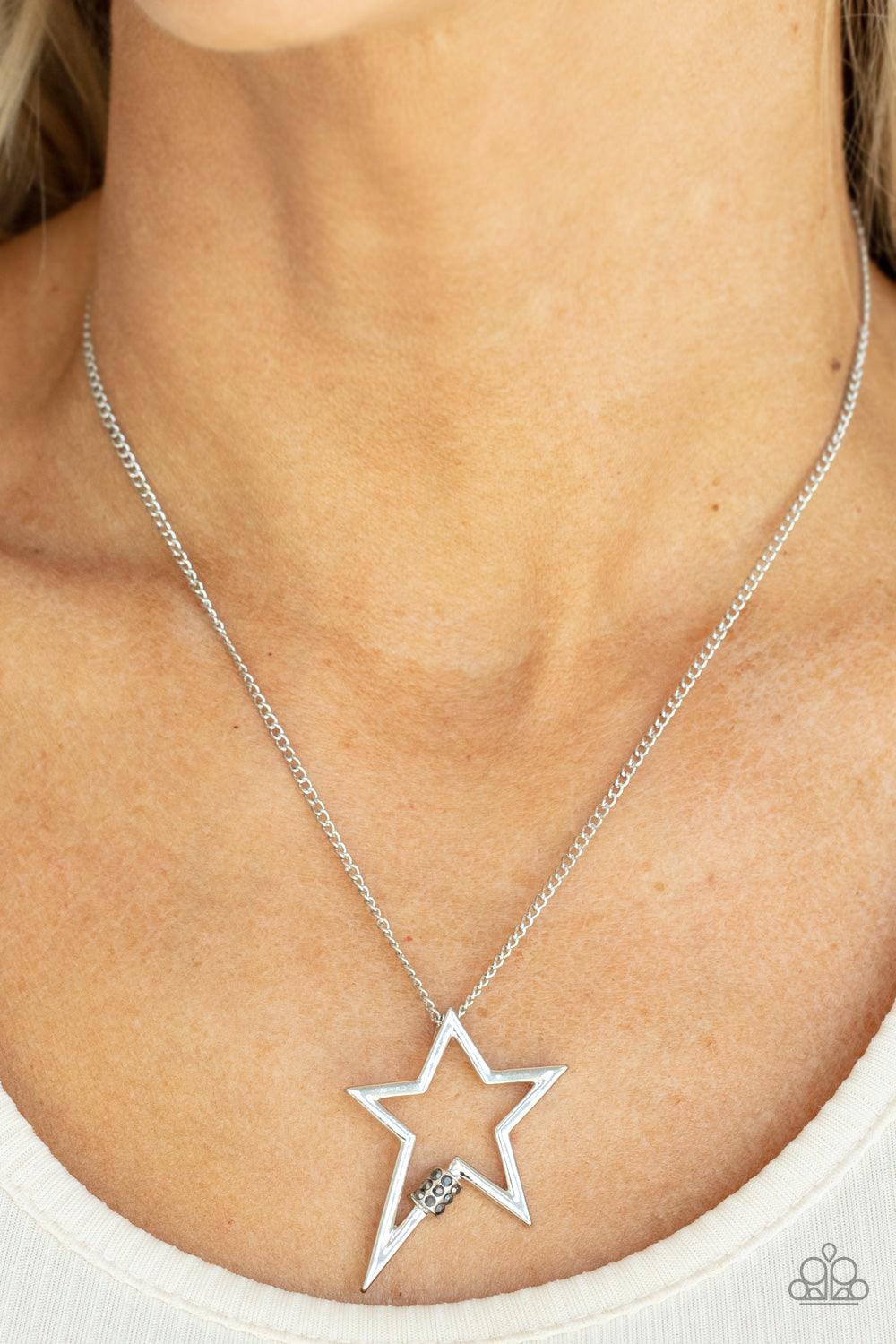 Paparazzi Accessories Light Up The Sky - Silver Infused with a dainty hematite rhinestone beaded accent, a striking silver star glides along a shiny silver chain below the collar, creating a stellar pendant. Features an adjustable clasp closure. Sold as o