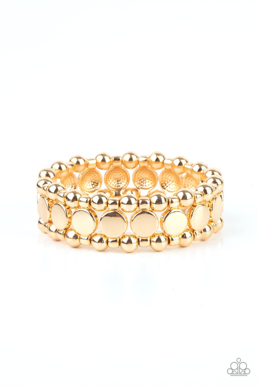 Paparazzi Accessories Metro Magnetism - Gold Glistening gold disc fittings and pairs of classic gold beads are threaded along stretchy bands around the wrist that connect into a bold industrial display around the wrist. Sold as one individual bracelet. Je