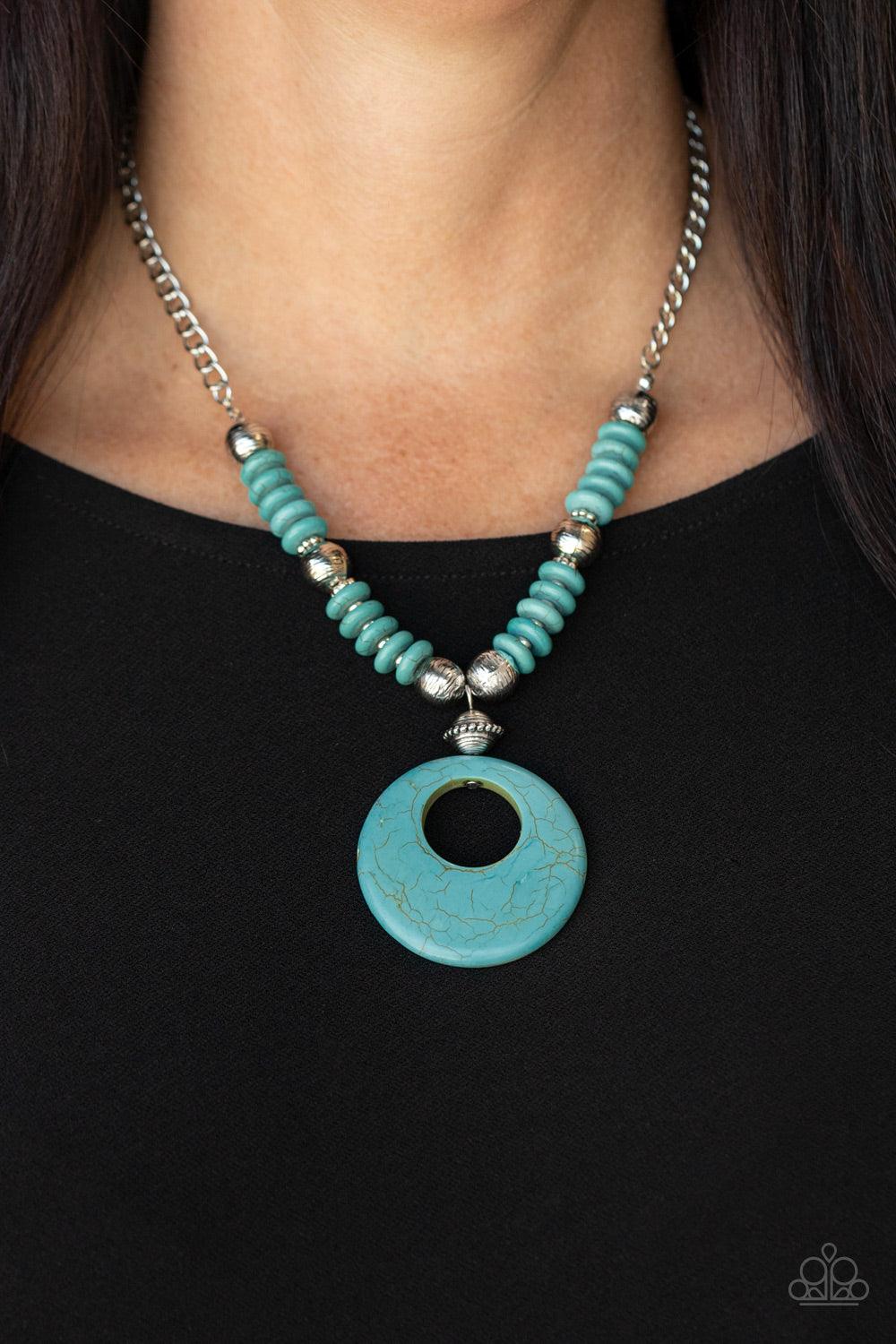 Paparazzi Accessories Oasis Goddess - Blue Infused with dainty silver accents, mismatched silver beads and turquoise stone discs are threaded along an invisible wire below the collar. An oversized turquoise stone pendant swings from the center of the eart