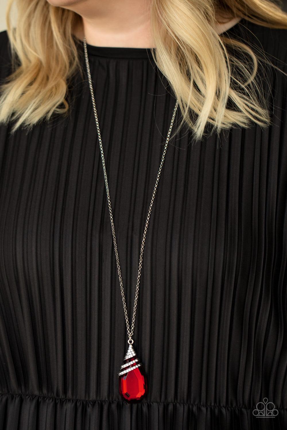 Paparazzi Accessories Demandingly Diva - Red Capped in a white rhinestone encrusted fitting, glittery silver ribbons of white rhinestones delicately wrap around the top of a dramatically oversized red teardrop gem. The fiery red pendant swings from the bo