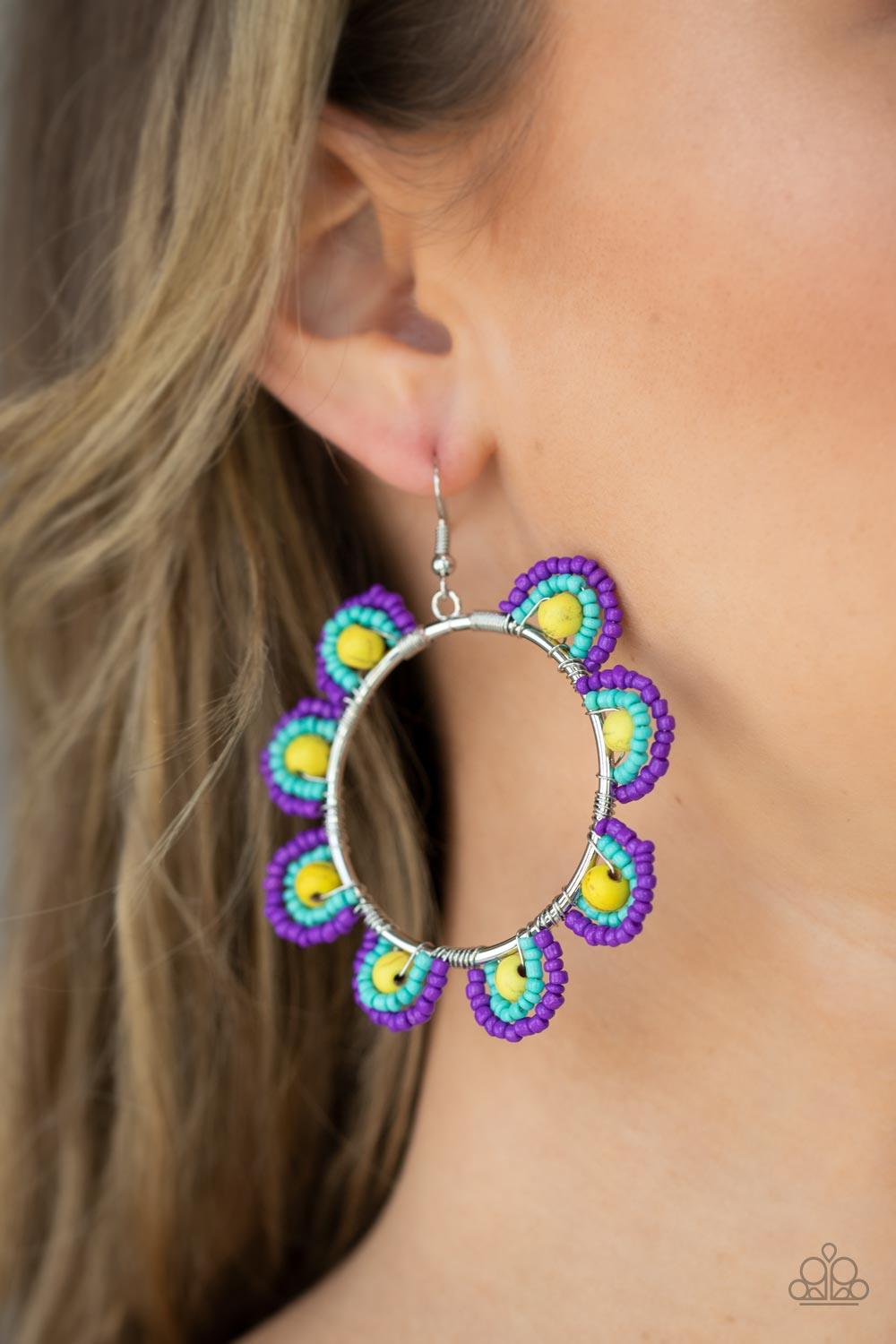 Paparazzi Accessories Groovy Gardens - Yellow Infused with sunny yellow stone bead centers, rows of purple and turquoise seed beads are threaded along dainty wires along the outside of a shiny silver hoop for a vivacious floral look. Earring attaches to a
