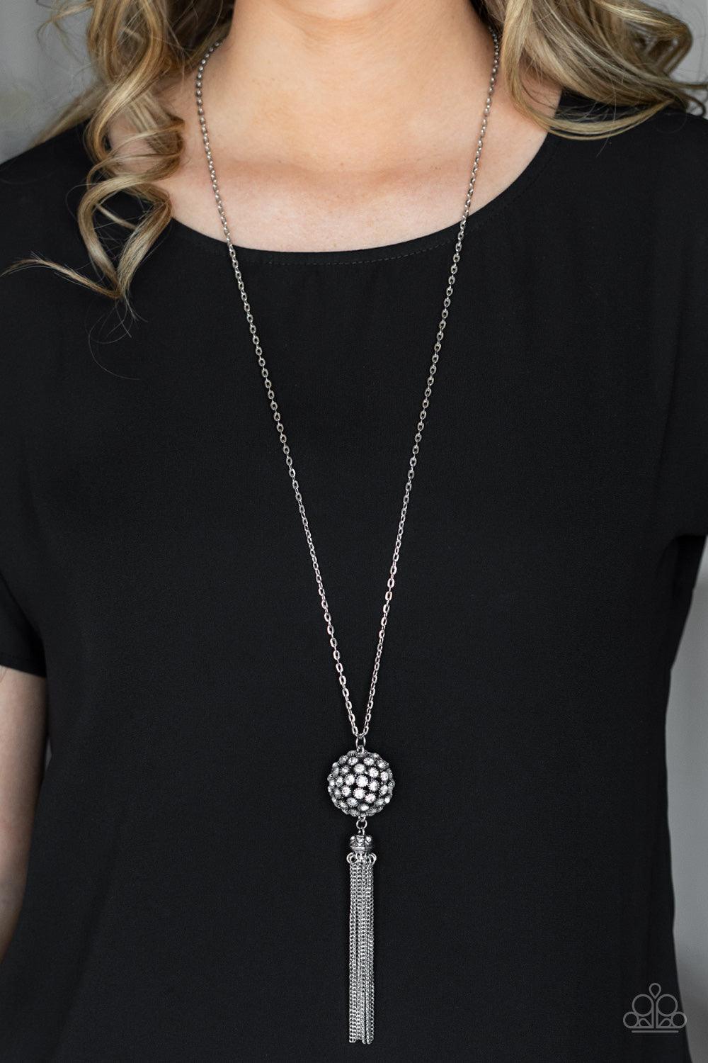 Paparazzi Accessories Rhinestone Revolution - White Infused with silver studded fittings, a glittery collection of sparkly white rhinestones coalesce into a dramatic pendant at the bottom of a lengthened silver chain. Capped in a rhinestone dotted frame,
