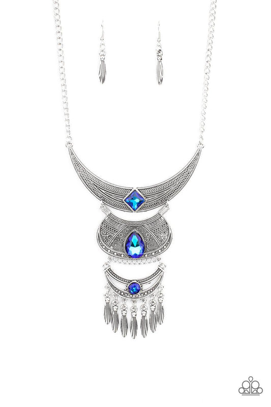 Paparazzi Accessories Lunar Enchantment - Blue Embossed in studded, geometric, and paisley filigree-like patterns, three mismatched silver half moon plates dramatically link below the collar. Featuring an entrancing blue UV shimmer, an oversized collectio
