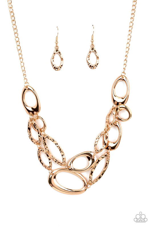 Paparazzi Accessories Game OVAL - Gold A mismatched assortment of asymmetrical and hammered gold ovals delicately links below the collar, creating refined metallic layers. Features an adjustable clasp closure. Sold as one individual necklace. Includes one