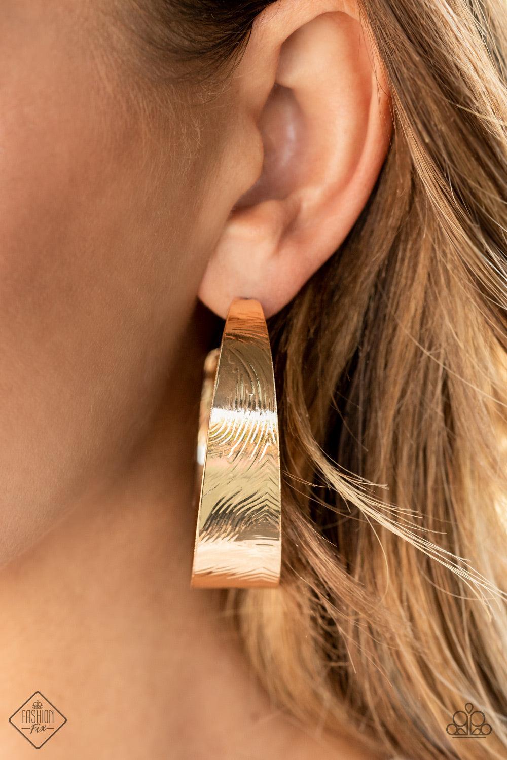 Paparazzi Accessories Curve Crushin - Gold Embossed in whirling geometric details, a thick gold hoop boldly curls around the ear for a curvaceous look. Earring attaches to a standard post fitting. Hoop measures approximately 2" in diameter. Sold as one pa