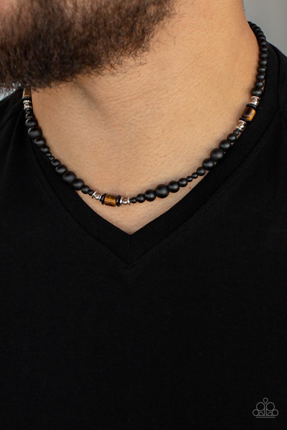 Paparazzi Accessories Stone Synchrony - Brown Grounding sections of dainty silver beads and Tiger's eye stone accents adorn a strand of black stone beads, creating an earthy compliment below the collar. Features an adjustable clasp closure. Sold as one in