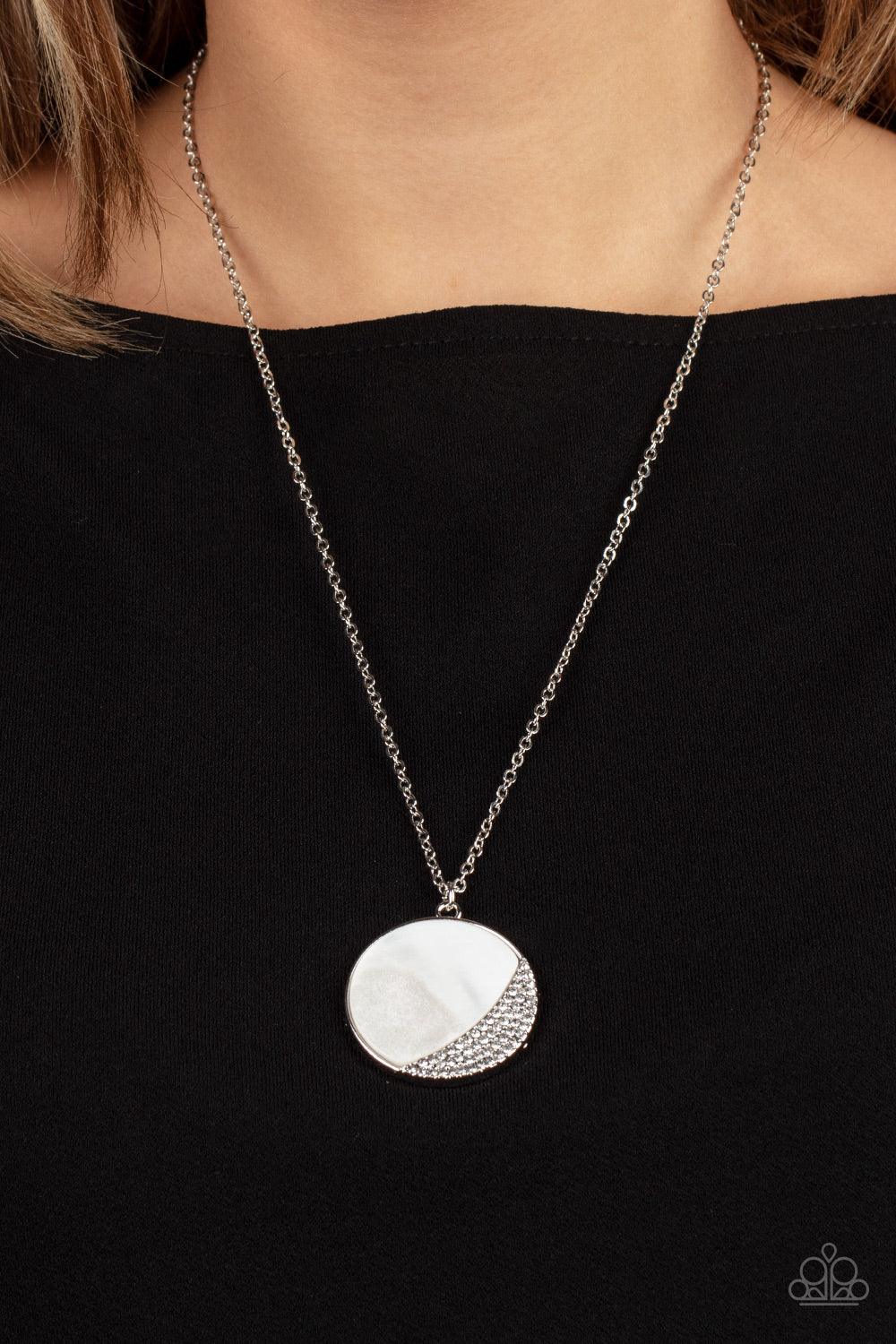 Paparazzi Accessories Oceanic Eclipse - White A white shell-like pendant is eclipsed in a half moon silver frame that is encrusted in sparkly white rhinestones, creating a shimmery display below the collar. Features an adjustable clasp closure. Sold as on