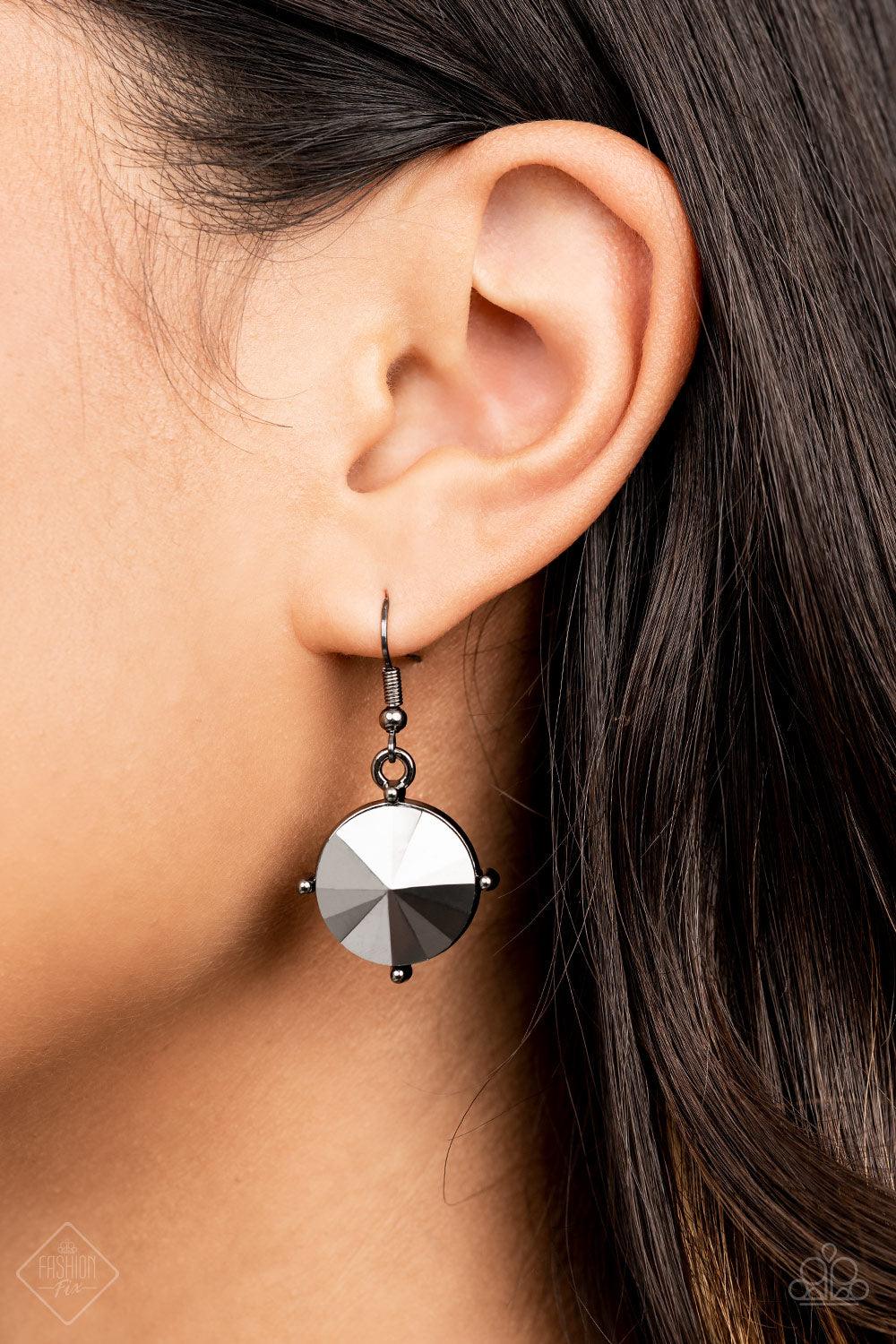 Paparazzi Accessories The SHOWCASE Must Go On - Black Attached to glistening gunmetal chains, a dramatic collection of oversized hematite rhinestones boldly links into a smoldering statement piece below the collar. Features an adjustable clasp closure. So