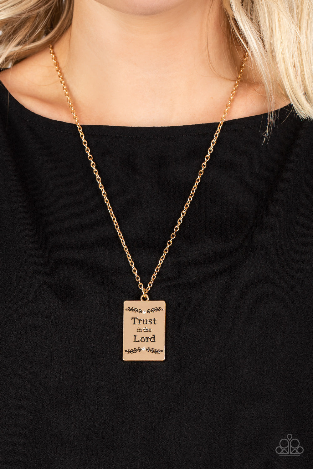 Paparazzi Accessories All About Trust - Gold Bordered in leafy patterns and dainty white rhinestones, the center of a gold rectangular frame is stamped in the phrase, "Trust in the Lord," for an inspiring finish. Features an adjustable clasp closure. Sold