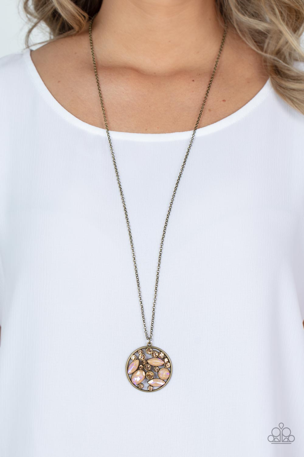 Paparazzi Accessories Iridescently Influential - Brown A bubbly collection of golden topaz rhinestones and round and marquise iridescent gems coalesce inside of a burnished brass frame, creating an effervescent pendant at the bottom of a brass chain. Feat