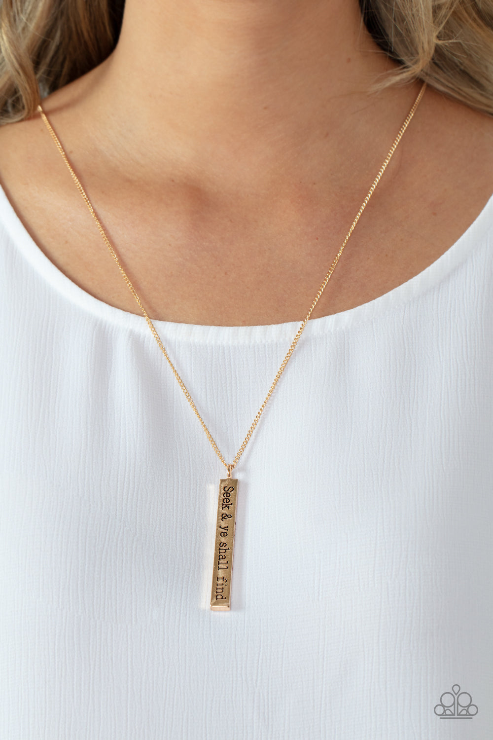 Paparazzi Accessories Matt 7:7 - Gold A flattened rectangular pendant is stamped in the biblical phrase, "Seek & ye shall find. Matt7:7," creating an inspirational sight at the bottom of an extended gold chain. Features an adjustable clasp closure. Sold a