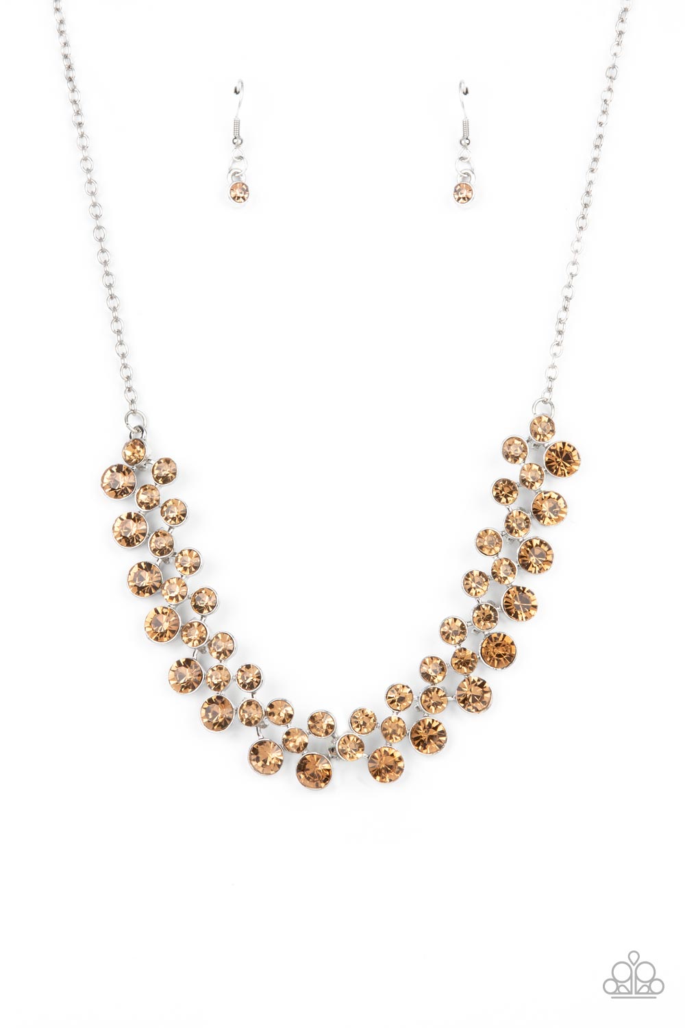 Paparazzi Accessories Won The Lottery - Brown Encased in sleek silver frames, staggered rows of bubbly golden topaz rhinestones effervescently link below the collar for a glamorous pop of sparkle. Features an adjustable clasp closure. Sold as one individu