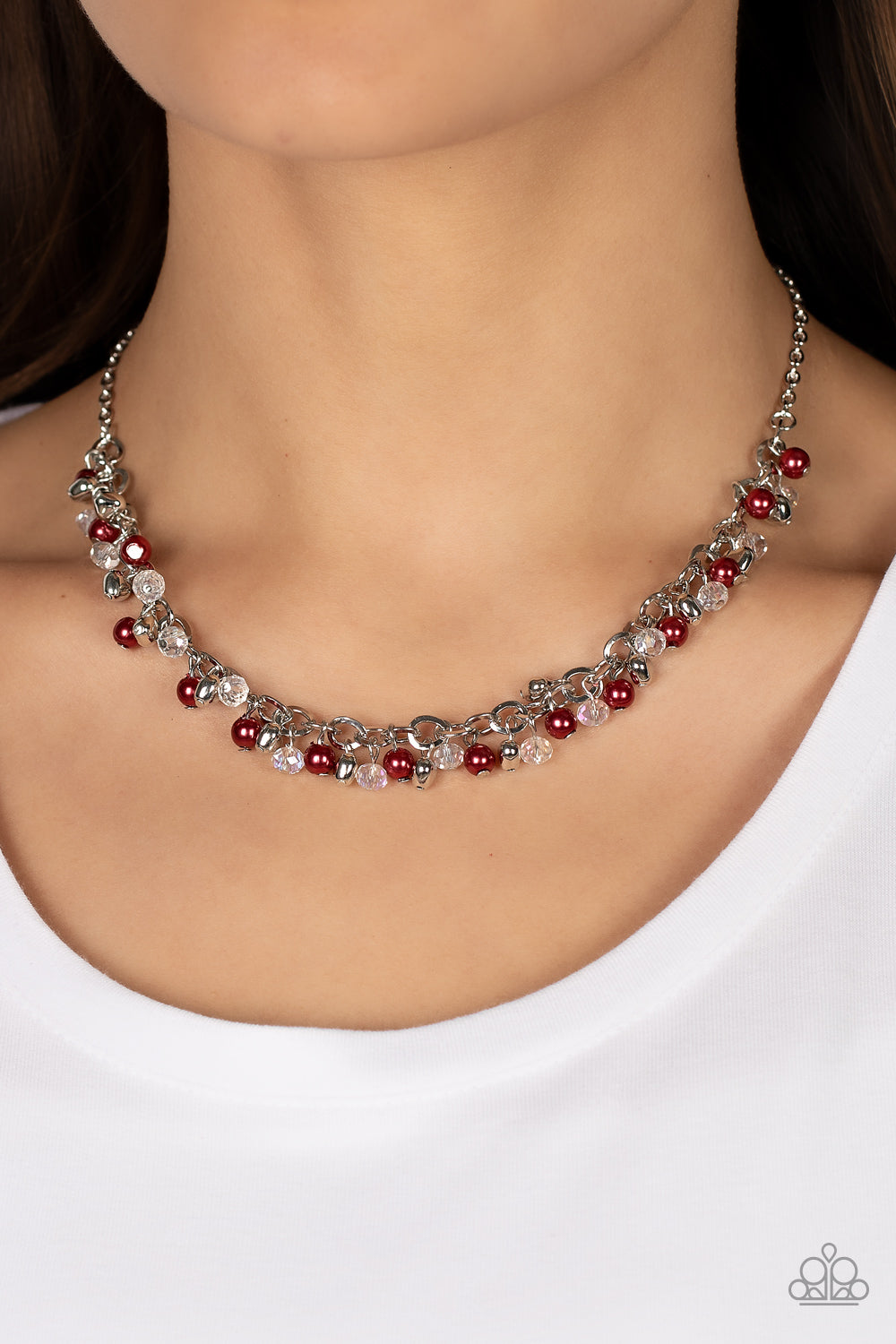 Paparazzi Accessories Soft-Hearted Shimmer - Red A dainty collection of red pearls, white crystal-like accents, and silver heart beads delicately clusters along a dainty silver chain, creating a flirtatious fringe below the collar. Features an adjustable