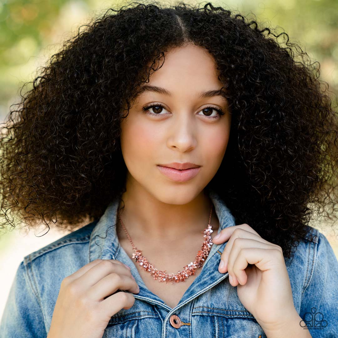 Paparazzi Accessories Fearlessly Floral - Copper Featuring textured petals, a dainty collection of shiny copper flower frames and glassy white rhinestones delicately cluster along the bottom of a shiny copper chain for a flirtatious floral look below the
