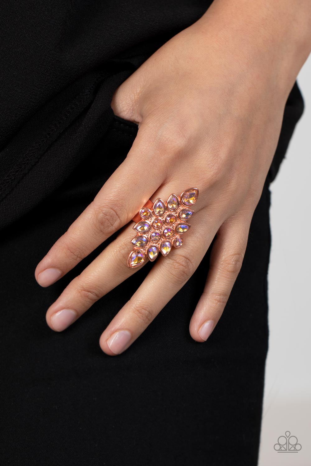Paparazzi Accessories Combustible Iridescence - Copper Round and teardrop iridescent rhinestones fan out across a diamond shaped shiny copper frame, resulting in a stellar centerpiece atop the finger. Features a stretchy band for a flexible fit. Sold as o