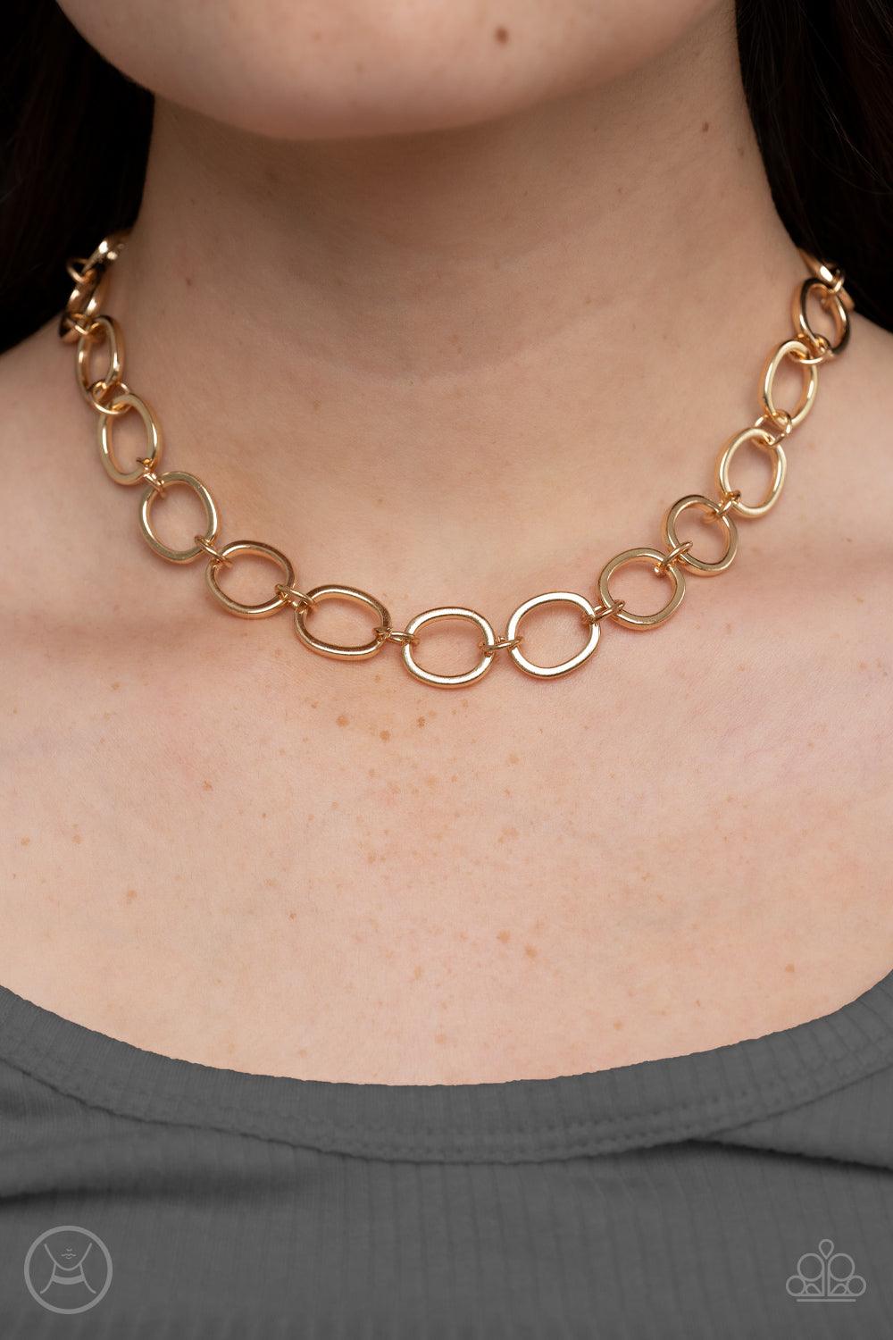 Paparazzi Accessories 90s Nostalgia - Gold Imperfectly shaped gold circles link together around the neck for a gritty industrial statement. Features an adjustable clasp closure. Sold as one individual choker necklace. Includes one pair of matching earring
