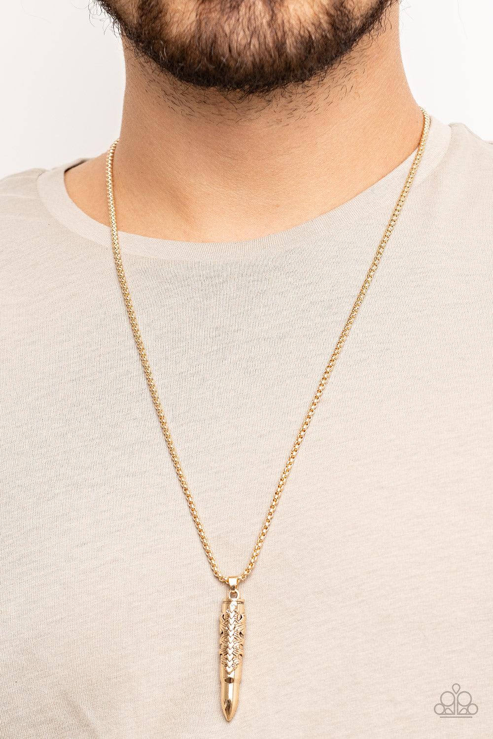 Paparazzi Accessories Mysterious Marksman - Gold Wrapped in a tribal inspired motif, a shiny gold bullet-like pendant swings from the bottom of a rounded strand of gold box chain for a rugged look. Features an adjustable clasp closure. Sold as one individ