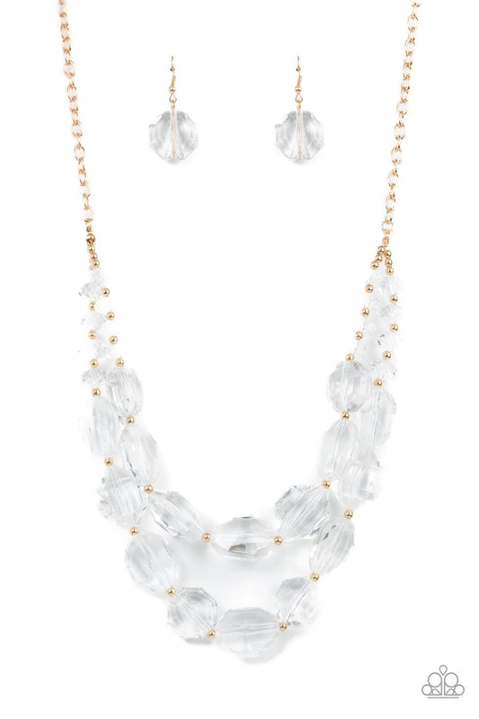 Paparazzi Accessories Icy Illumination - Gold Separated by dainty gold beads, an icy collection of oversized and faceted white gems are threaded along invisible wires below the collar, resulting in prismatic layers. Features an adjustable clasp closure. S