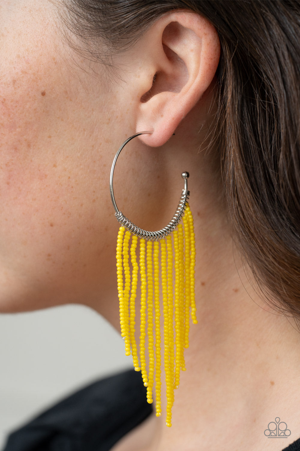 Paparazzi Accessories Saguaro Breeze - Yellow Strands of dainty Illuminating seed beads stream out from the bottom of a classic silver hoop, resulting in a flirtatiously tasseled look. Earring attaches to a standard post fitting. Hoop measures approximate
