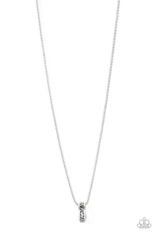 Paparazzi Accessories Emotion Potion - Silver Embossed in a band of zigzagging texture, an antiqued silver ring glides along a strand of silver box chain across the chest in a rustic fashion. Features an adjustable clasp closure. Sold as one individual ne