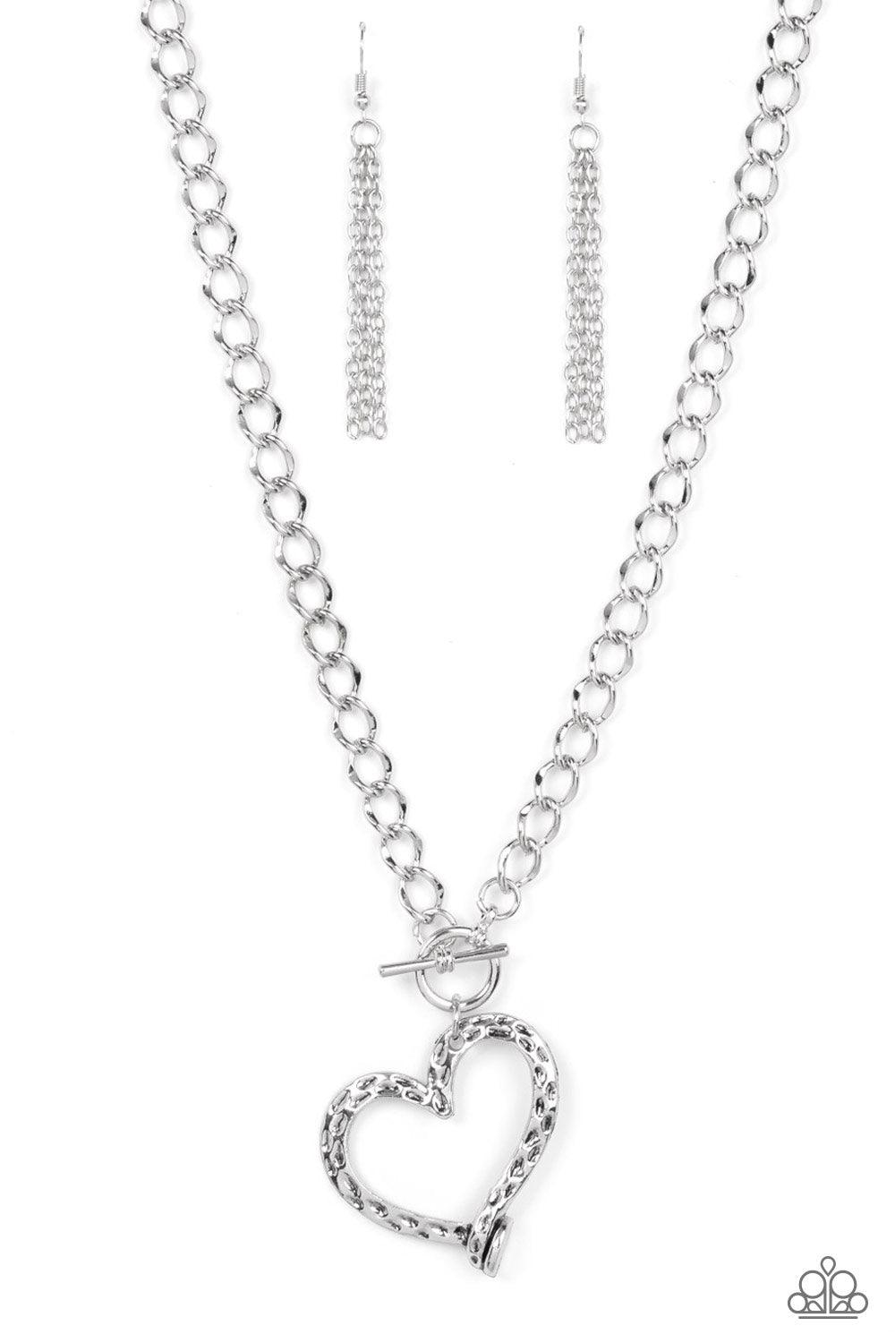 Paparazzi Accessories Reimagined Romance - Silver A hammered silver heart frame gently twists from a toggle closure at the bottom of a chunky silver chain, resulting in a romantically rustic pendant. Features a toggle closure. Sold as one individual neckl